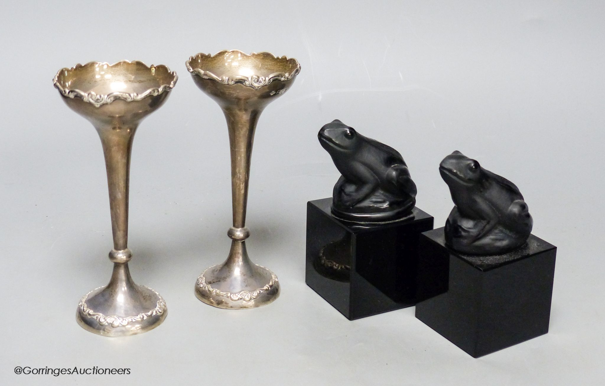 A pair of silver specimen vases, height 14cm, and a pair of black glass frogs